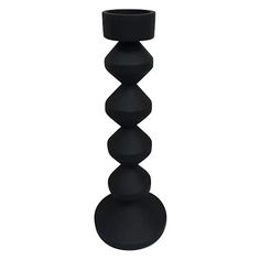 a tall black candle holder on a white background