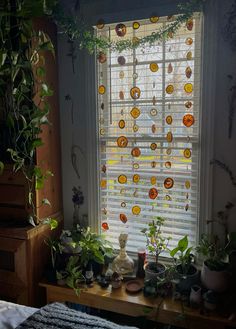 there is a window decorated with oranges and green plants in the room next to it