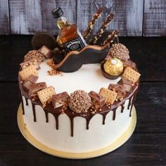 a cake decorated with chocolate, marshmallows, and other treats on a table