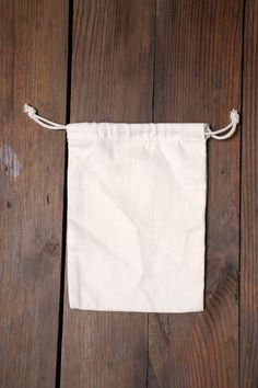 a white bag sitting on top of a wooden floor