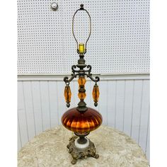 an old fashioned lamp is sitting on a table