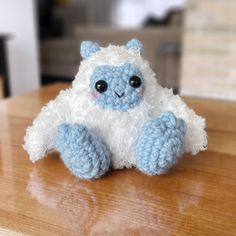 a small stuffed animal sitting on top of a wooden table