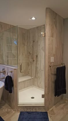 a bathroom with a walk in shower next to a bathtub