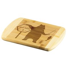 a wooden cutting board with an image of a bear holding a sign