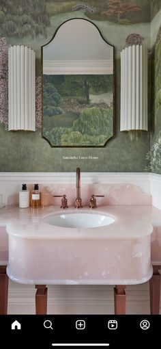 a white sink sitting under a mirror next to a wall mounted faucet in a bathroom