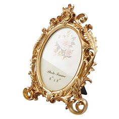 an ornately decorated gold frame holds a personalized wedding card and keeps it close to the ground