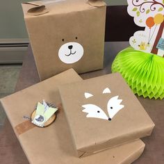 some brown paper bags sitting on top of a table next to other boxes and decorations