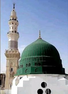 a large white building with a green dome