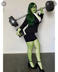 a woman dressed in green and black holding a barbell