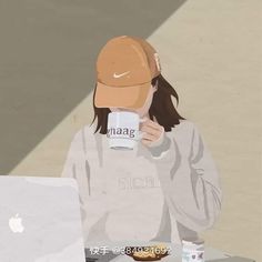 a woman sitting at a table with a laptop and coffee cup in front of her face