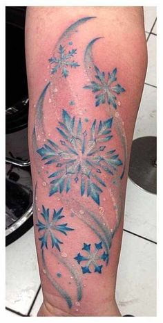 a snowflake tattoo is shown on the arm and leg, with blue ink