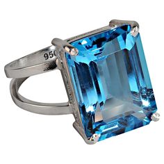 Stunning Swiss Blue Topaz Sterling Silver Ring – A Timeless Masterpiece Showcase your style with this exquisite Swiss Blue Topaz ring, featuring a breathtaking emerald-cut gemstone in a handcrafted Sterling Silver setting. This striking piece is the perfect combination of brilliance, craftsmanship, and timeless elegance. Key Features Magnificent Gemstone: The vibrant Swiss Blue Topaz measures 15 x 11 mm and weighs an impressive 11.74 carats, radiating irresistible brilliance. Handcrafted Design: