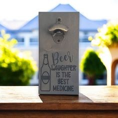 a beer bottle opener with the words beer laughter is the best medicine written on it