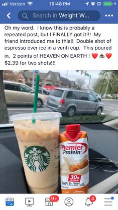 a cup of coffee next to a drink on the dashboard of a car