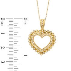 Treat the one you love to this vintage-inspired diamond heart pendant. Crafted in sterling silver with warm 14K gold plate, this heart-shaped design features an inner border of shimmering round diamonds surrounded by a lacy scalloped frame set with additional round accent diamonds. The diamond-lined bale is a thoughtful touch. Glistening with 1/3 ct. t.w. of diamonds and polished to a brilliant shine, this heart suspends close to hers along an 18.0-inch box chain that secures with a spring-ring clasp. Heirloom Heart Jewelry With Diamond Accents, Heirloom Heart-shaped Jewelry With Diamond Accents, Gold Heart Cut Jewelry With Halo Setting, Valentine's Day Yellow Gold Halo Jewelry, Valentine's Day Gold Jewelry With Halo Setting, Gold Jewelry With Halo Setting For Valentine's Day, Gold Heart Necklace With Single Cut Diamonds For Anniversary, Yellow Gold Jewelry With Halo Setting For Valentine's Day, Yellow Gold Heart Jewelry With Halo Setting