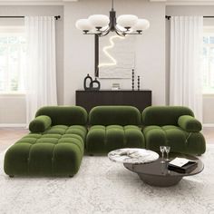 a living room with green couches and white rugs