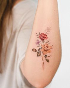 a woman with a flower tattoo on her arm