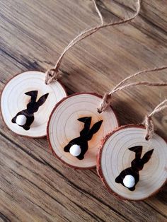 three pieces of wood that have been decorated with black and white bunny ears on them