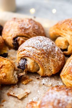 croissants with powdered sugar and raisins on top