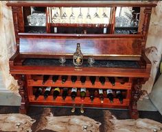 an old piano with wine bottles on it