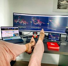 a person sitting at a desk with two computer monitors