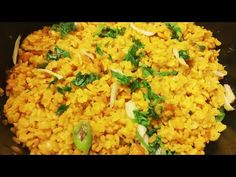 rice and vegetables are being cooked in a pan