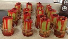 several cups filled with food sitting on top of a counter