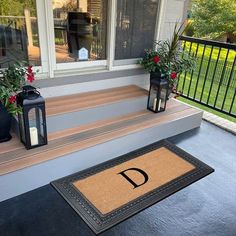 a front porch with a welcome mat on it