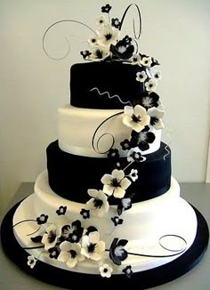 a three tiered wedding cake with white and blue flowers