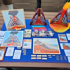 a table topped with pictures and cards on top of a blue cloth covered tablecloth