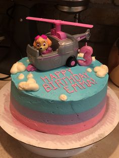 a birthday cake with a dog in a car on top