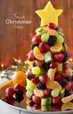 a christmas tree made out of fruit on a plate