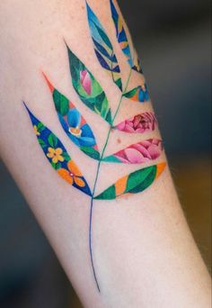 a colorful flower and leaf tattoo on the right arm, which is painted with watercolors