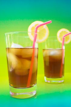 two glasses filled with liquid and topped with straws