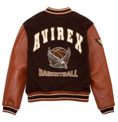 DESCRIPTION & FEATURE  Classic Avirex varsity jacket with a mix of 100% French lamb leather sleeves and wool body. Graphic “Team Eagle” chenille and embroidery basketball patch art in back, and winged basketball patch at sleeve. Leather and wool Varsity jacket “Team Eagle” chenille art applique and embroidery basketball in back Front “A” crest patch Snap front button closure with Avirex hardware Striped rib knit collar cuffs and hem Avirex Print applique lining art Model is 6 feet tall and wears Body Graphic, Cloth Ideas, College Jacket, Leather Varsity Jackets, College Jackets, Varsity Jackets, Moda Punk, Leather Sleeves, Leather Shirt