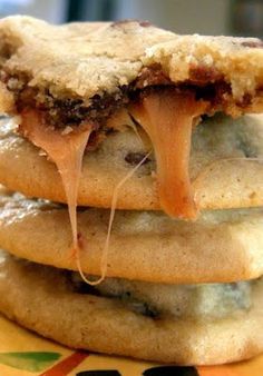 a stack of cookies sitting on top of a yellow and green plate covered in icing