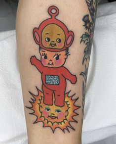 a person with a small tattoo on their arm and leg that has an image of a teddy bear wearing a space suit