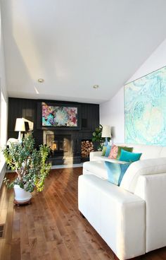 a living room filled with furniture and a flat screen tv mounted to the side of a wall