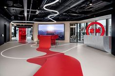 a large room with red chairs and white flooring