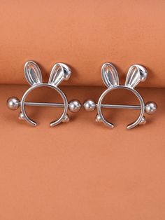 two silver ear studs with ears on them