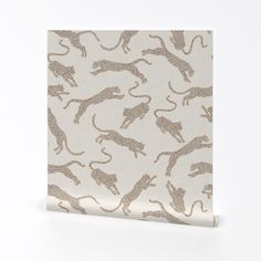 a white and brown wallpaper with leopards on it's back side, in front of a white background