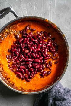 a pot filled with red beans on top of a table