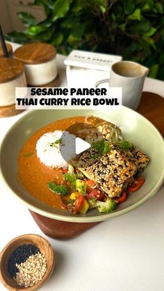 a bowl filled with rice and vegetables on top of a table