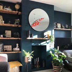 a living room filled with furniture and a fire place next to a mirror on the wall