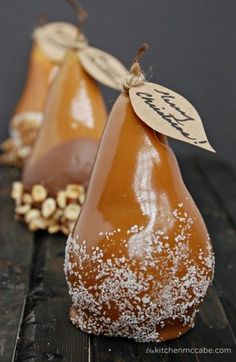 two pears are sitting on top of a piece of wood with white sprinkles