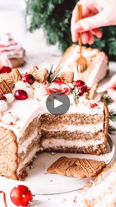 someone is cutting into a cake with white frosting and cranberry toppings