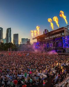 a large crowd at a concert with bright lights