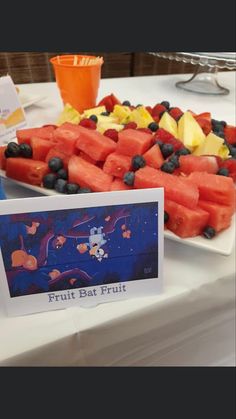 watermelon slices, blueberries, and other fruit are arranged on a table