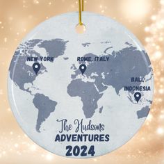 a christmas ornament with pins on the map of the world in blue and white