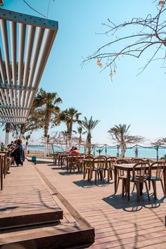 tables and chairs are set up on the boardwalk